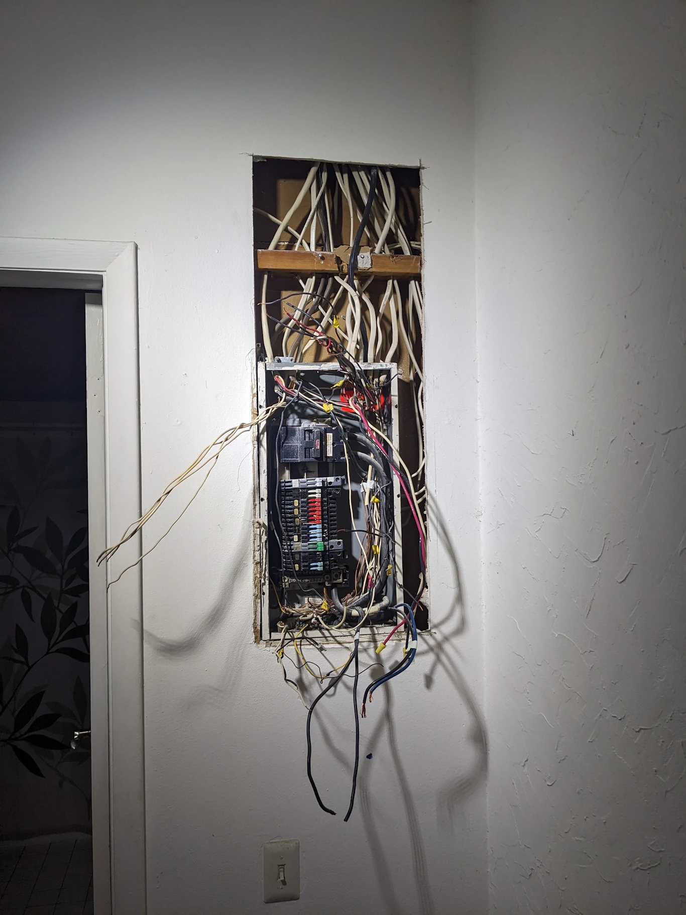 Panel rewire in progress with existing branch circuits exposed