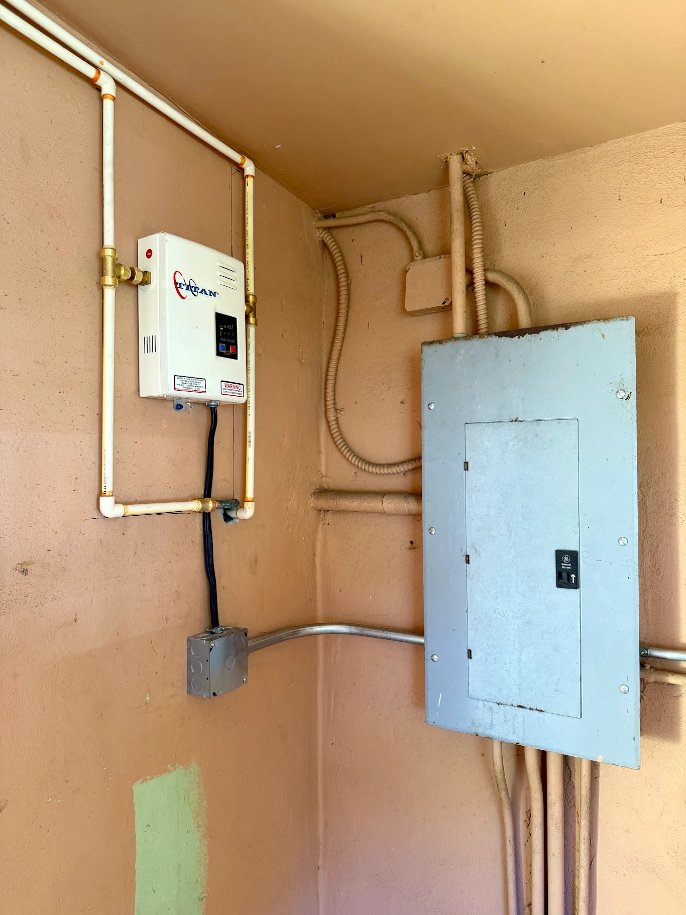 Sub-panel and conduit runs feeding a tankless water heater