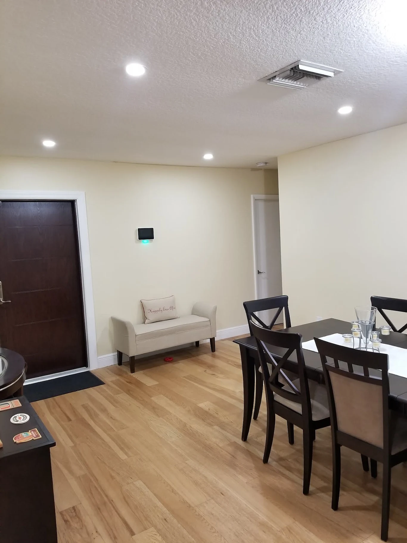 Entryway and dining area with recessed lighting installed